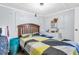 Bedroom with a colorful bedspread, neutral walls, and natural light at 8989 E Cherokee Dr, Canton, GA 30115