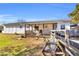 Charming single-story home with a cozy front porch and well-maintained lawn at 8989 E Cherokee Dr, Canton, GA 30115