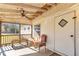 Cozy screened front porch with vintage seating and natural light at 8989 E Cherokee Dr, Canton, GA 30115