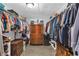 Spacious walk-in closet with wooden dressers and plenty of storage space at 8989 E Cherokee Dr, Canton, GA 30115