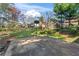 Expansive backyard featuring a basketball court, lush lawn, and mature trees at 951 Orchard Mill Ln, Lawrenceville, GA 30043