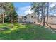 A spacious backyard with a well-maintained lawn, concrete patio, and mature trees for added privacy at 951 Orchard Mill Ln, Lawrenceville, GA 30043
