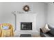 A lovely fireplace with a white brick surround and wooden mantle creates a cozy focal point at 951 Orchard Mill Ln, Lawrenceville, GA 30043