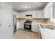 Well-equipped kitchen with stainless steel appliances and white cabinetry at 951 Orchard Mill Ln, Lawrenceville, GA 30043