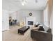 Bright living room features a fireplace, ceiling fan, and sleek gray sofa, blending comfort and style at 951 Orchard Mill Ln, Lawrenceville, GA 30043