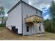 The back exterior of a two-story home includes a small elevated deck and a walk out basement at 108 Deer Xing, Temple, GA 30179