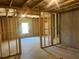 Unfinished basement featuring exposed framing, a window, and stairs, awaiting customization for your dream space at 108 Deer Xing, Temple, GA 30179