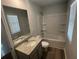 Bright bathroom featuring a vanity with granite counters and tub with shower at 108 Deer Xing, Temple, GA 30179