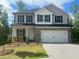 Charming two-story home featuring a gray and white exterior, a two-car garage, and newly landscaped front yard at 108 Deer Xing, Temple, GA 30179