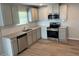 Modern kitchen showcasing stainless steel appliances, granite countertops, and gray cabinetry at 108 Deer Xing, Temple, GA 30179