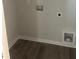 Convenient laundry room hookups on wood-look flooring, perfect for easy chores at 108 Deer Xing, Temple, GA 30179