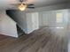 Bright open-concept living room featuring hardwood floors, staircase, and neutral color palette at 108 Deer Xing, Temple, GA 30179