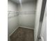 Unfinished walk-in closet with carpeted flooring and wire shelving awaiting personalization and organization at 108 Deer Xing, Temple, GA 30179