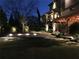 Backyard view showcasing stone patio with landscape lighting and outdoor living space at 1214 Oglethorpe Ne Ave, Brookhaven, GA 30319
