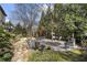 An expansive backyard featuring multiple seating areas, lush landscaping, and mature trees at 1214 Oglethorpe Ne Ave, Brookhaven, GA 30319