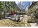 A backyard featuring multiple seating areas, lush landscaping, and mature trees at 1214 Oglethorpe Ne Ave, Brookhaven, GA 30319