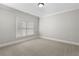 Bright bedroom featuring neutral walls, carpeting, and window with blinds at 1214 Oglethorpe Ne Ave, Brookhaven, GA 30319