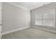 Bright bedroom featuring neutral walls, carpeting, and window with blinds at 1214 Oglethorpe Ne Ave, Brookhaven, GA 30319