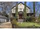 Beautiful two-story home with a welcoming porch, lush greenery, and a classic architectural style at 1214 Oglethorpe Ne Ave, Brookhaven, GA 30319