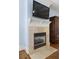 Fireplace with tv and mantel is the focal point in this bedroom at 1214 Oglethorpe Ne Ave, Brookhaven, GA 30319