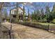 Charming two-story home featuring a gravel driveway, manicured landscaping, and inviting front porch at 1214 Oglethorpe Ne Ave, Brookhaven, GA 30319