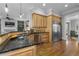 Elegant kitchen featuring granite countertops, stainless steel appliances, and hardwood floors at 1214 Oglethorpe Ne Ave, Brookhaven, GA 30319