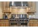 Gourmet kitchen with professional-grade stainless steel range and custom cabinets at 1214 Oglethorpe Ne Ave, Brookhaven, GA 30319