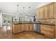 Spacious kitchen area with wood cabinets, stainless steel appliances, pendant lights, and a breakfast bar at 1214 Oglethorpe Ne Ave, Brookhaven, GA 30319