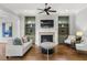 Cozy living room with fireplace, built-in shelving, and comfortable seating arrangement at 1214 Oglethorpe Ne Ave, Brookhaven, GA 30319