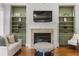 Comfortable living room featuring fireplace, custom built-ins, and stylish decor at 1214 Oglethorpe Ne Ave, Brookhaven, GA 30319