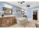 Bright bathroom features double vanities, a soaking tub, and tile flooring throughout at 1214 Oglethorpe Ne Ave, Brookhaven, GA 30319