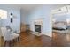 Bright main bedroom features hardwood floors, a fireplace, and a view into an additional bedroom at 1214 Oglethorpe Ne Ave, Brookhaven, GA 30319