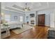 Spacious main bedroom with a tray ceiling, fireplace, and hardwood floors at 1214 Oglethorpe Ne Ave, Brookhaven, GA 30319