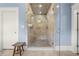 Tile shower in bathroom features dual shower heads, a built-in bench and a glass door at 1214 Oglethorpe Ne Ave, Brookhaven, GA 30319