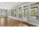 Bright sunroom with walls of windows, hardwood floors, and lots of natural light at 1214 Oglethorpe Ne Ave, Brookhaven, GA 30319