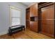 Spacious walk-in closet features hardwood floors, a window, built-in shelves, and ample storage at 1214 Oglethorpe Ne Ave, Brookhaven, GA 30319