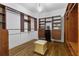 This walk-in closet features hardwood floors, built-in shelves, and ample storage space at 1214 Oglethorpe Ne Ave, Brookhaven, GA 30319