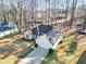 Well-maintained single-story home with a two-car garage, mature trees and lush green lawn at 170 Fairview Chase Rd, Covington, GA 30016