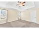 Bright bedroom with neutral carpet, large windows, and ceiling fan at 170 Fairview Chase Rd, Covington, GA 30016