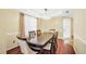 Well-lit dining room with seating for six and hardwood flooring at 170 Fairview Chase Rd, Covington, GA 30016