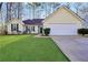 Charming single-story home features a well-maintained lawn, a two-car garage, and classic curb appeal at 170 Fairview Chase Rd, Covington, GA 30016