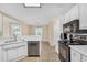 Well-lit kitchen features white cabinetry, stainless steel appliances, and an open layout at 170 Fairview Chase Rd, Covington, GA 30016