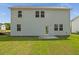New home backyard with spacious green lawn and partial view of the home's rear exterior at 202 Groveton Ct, Euharlee, GA 30145
