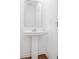 Half bath features white sink and mirror, pedestal sink with hardwood floors at 202 Groveton Ct, Euharlee, GA 30145