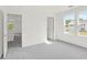 Bright, spacious bedroom with neutral carpet, complemented by natural light from two windows at 202 Groveton Ct, Euharlee, GA 30145