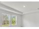 Bright bedroom featuring neutral walls, gray carpet, and windows with nature views at 202 Groveton Ct, Euharlee, GA 30145