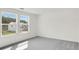 Bedroom with gray carpet, neutral walls, and windows offering views of another home at 202 Groveton Ct, Euharlee, GA 30145