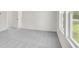 Spacious bedroom showcases neutral walls, gray carpet, and large windows with views at 202 Groveton Ct, Euharlee, GA 30145