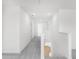 Upstairs hallway boasts gray carpet and white trim at 202 Groveton Ct, Euharlee, GA 30145