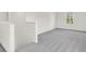 Upstairs hall with grey carpet, white trim, and a window with a view at 202 Groveton Ct, Euharlee, GA 30145